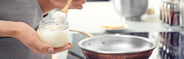 Woman cooking with coconut oil